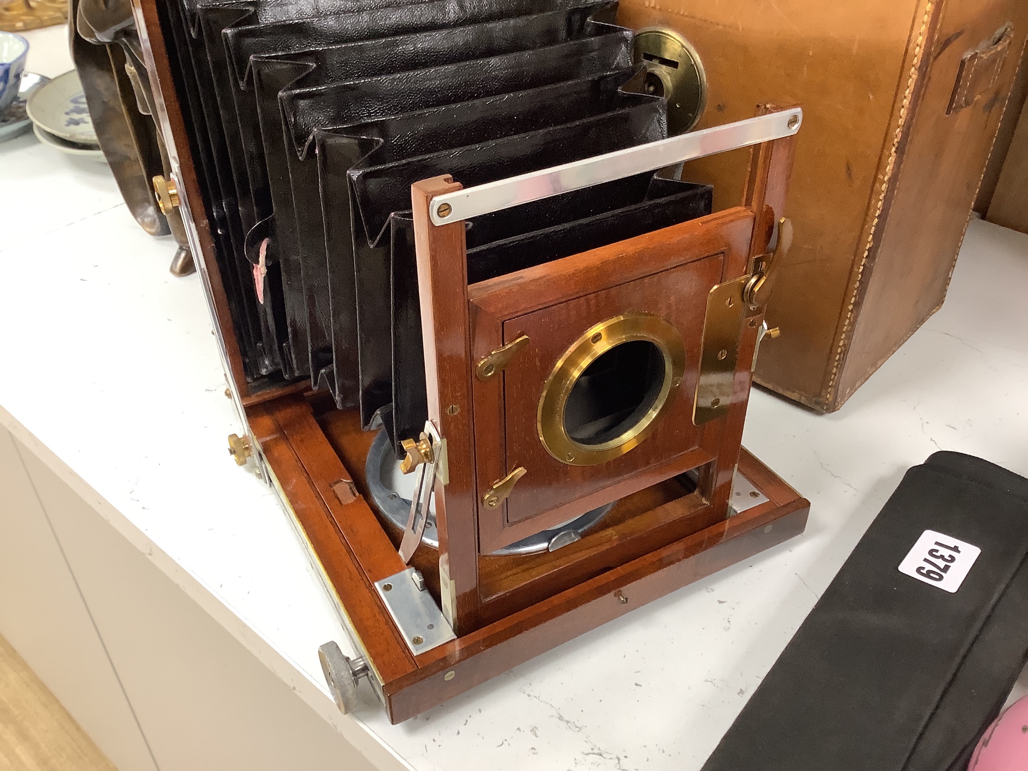 A leather cased Army & Navy auxiliary mahogany and brass folding camera, Newton & Co. Lens